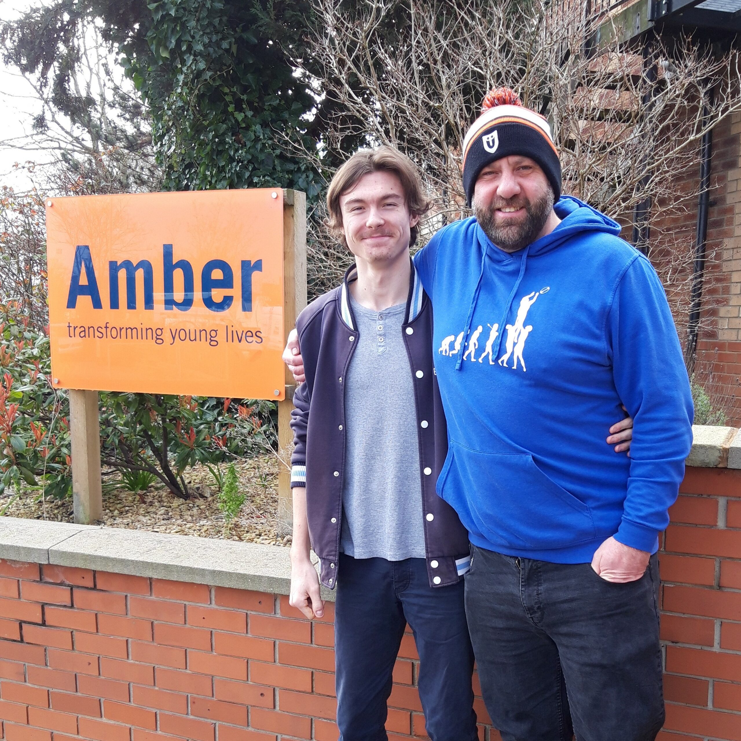 Picture of Callum with Team Leader Phil next to the Amber sign