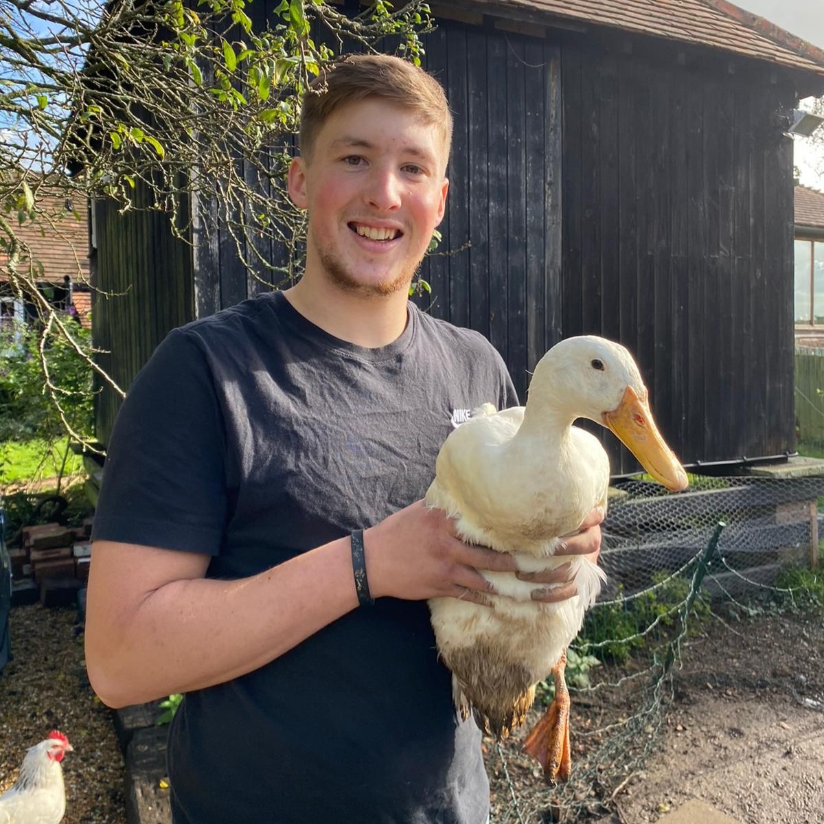 Picture of Tyler at Froggets Farm Flowers holding a white duck